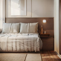 Minimalist dimple wall sconce providing warm white LED lighting in a serene Scandinavian bedroom
